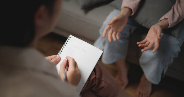 istock Asian therapists writing down notes during therapy with female patient 1766045872