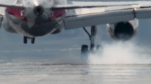 Close-Up of Plane Tire Touching Down in Slow Motion with Puff of Smoke