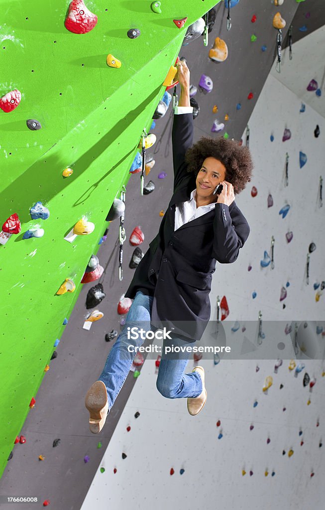 young business woman hanging at wall, beautiful girl young business woman hanging at wall, beautiful girl. she is in a gymnasium Chance Stock Photo