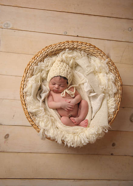 istock African American Baby Sleeping Peacefully in Basket WIth Hands Folded 176606589