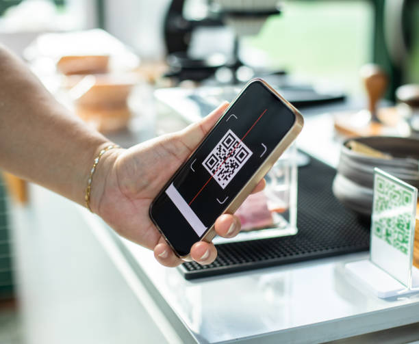 istock Selective focus to hand holding smartphone to scanning simulate QR code on tag. Customer hand making payment to accepted generate digital pay without money. 1766066691
