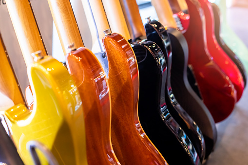 Selective focus to electric guitar in music shop, many electric guitars, pop rock artist song music and entertainment instrument. Studi shop.