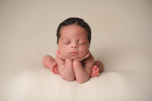 istock African American Newborn Boy Sleeping With Head on Hands 176606848