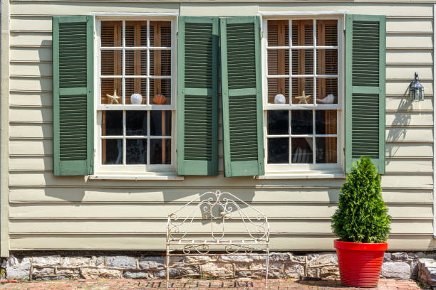 istock A wire bench and fir tree in red pot in front of two windows 1766069358