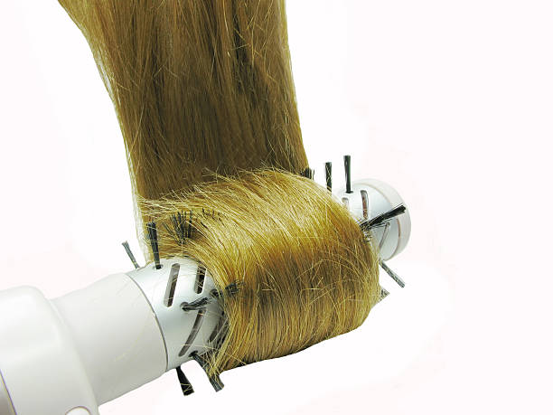 istock brush dryer with dark shiny hair in it 176608544