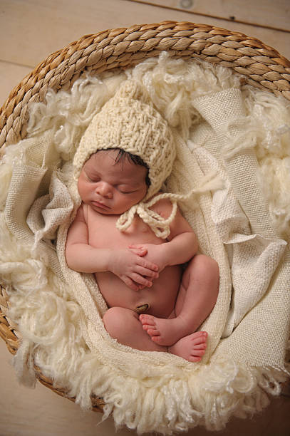istock African American Baby Sleeping Peacefully in Basket WIth Hands Folded 176608732