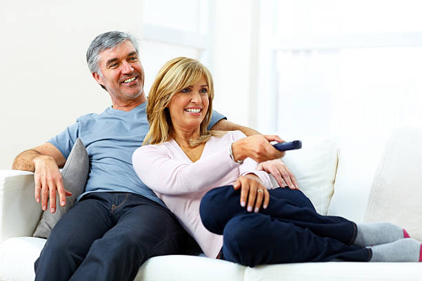 istock Relaxed mature couple watching television at home 176609137