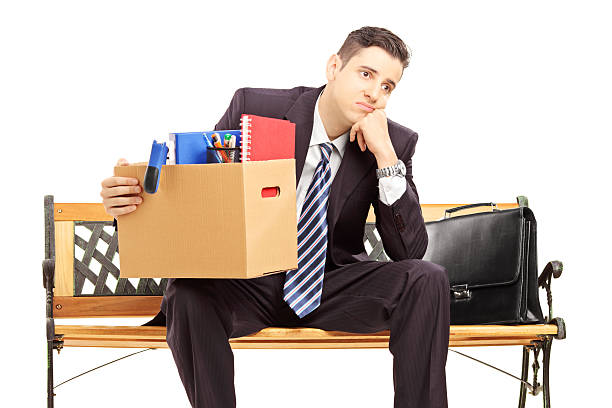 istock Disappointed man in a suit sitting on bench with box 176609758