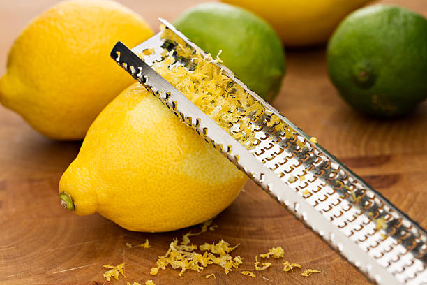 zest restaurant lemons and limes - grater photos et images de collection