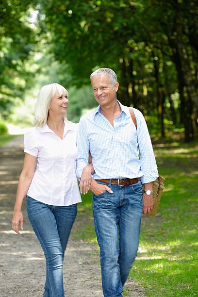 istock Mature/ Senior Couple Strolling Through The Park 176612588