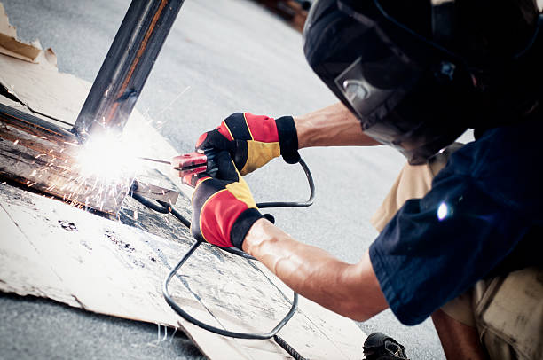 Welder at work Metal worker / welder welding metal outside. welder engineering construction bright stock pictures, royalty-free photos & images