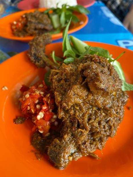 istock Fried duck with sambal and lalapan on orange plate 1766141068