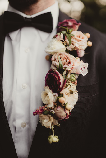 Man in suit for wedding wearing corsage