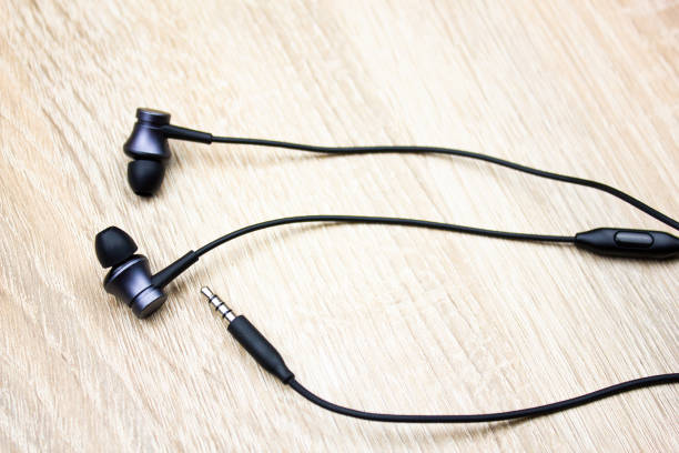 istock Wired headphones. Wired headset. Headphones on the table. 1766149682