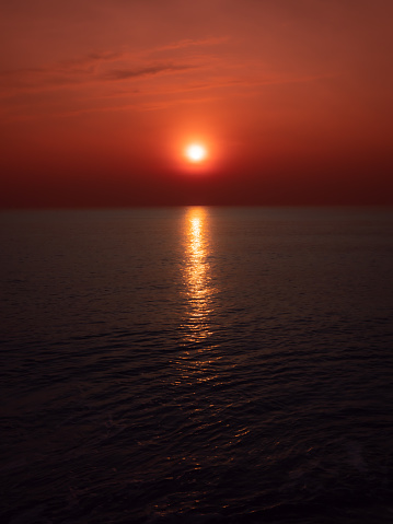 The Sunrise on The Cha-am Beach in Phetchaburi Province Thailand  behind The Red Sky