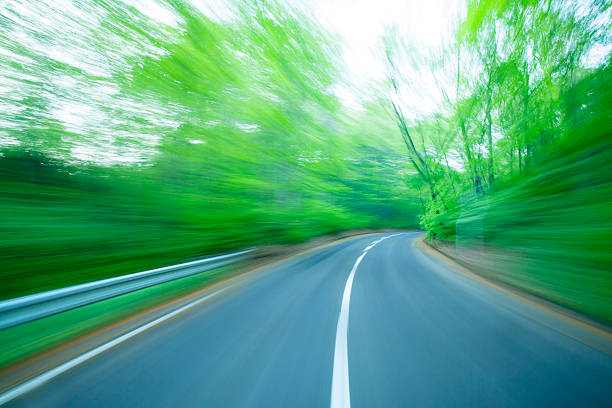 istock Road in motion blur at green forest 176618888