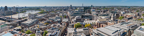 London cityscape panorama over Thames and downtown landmarks UK Panoramic view over the rooftops and roads, spires and squares of London, along the Embankment to the Festival Hall and London Eye, the palaces of Whitehall and Westminster and to the office buildings, Paternoster Square and narrow streets of the City of London downtown financial center. ProPhoto RGB profile for maximum color fidelity and gamut. paternoster square stock pictures, royalty-free photos & images