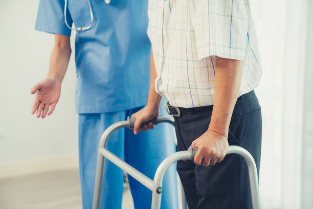 istock Physiotherapist assists her contented senior patient on folding walker. 1766210054