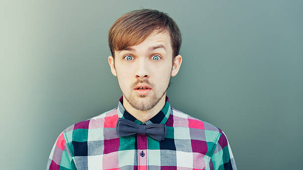 istock Young surprised man in shirt with bowtie 176621066
