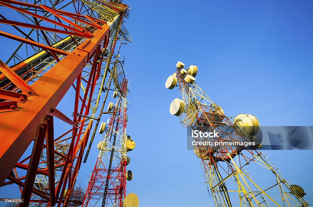 Telecommunication tower against the blue sky Telecommunication mast with microwave link and TV transmitter antennas with a bit morning sunlight  . Antenna - Aerial Stock Photo