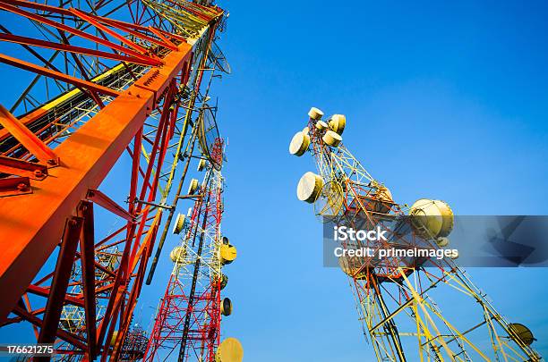 Telecommunication Tower Against The Blue Sky Stock Photo - Download Image Now - Antenna - Aerial, Attached, Blue