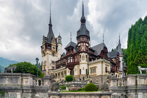 October 30, 2023: Sinaia, Romania - Peles Castle. Peles Castle is a castle in Romania located in Sinaia. This photo shows the castle from the exterior and was taken during a rainy day.