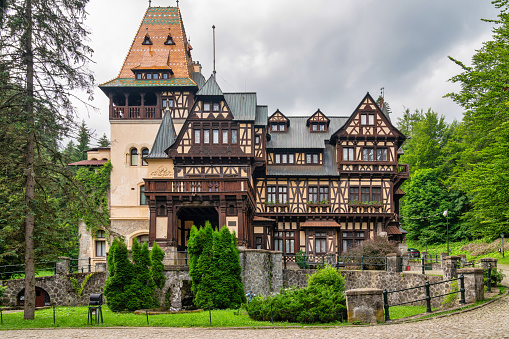 October 30, 2023: Sinaia, Romania - Peles Castle. Peles Castle is a castle in Romania located in Sinaia. This photo shows the castle from the exterior and was taken during a rainy day.