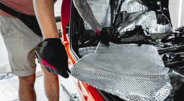 istock Tunning service worker install soundproofing material inside car interior 1766232448