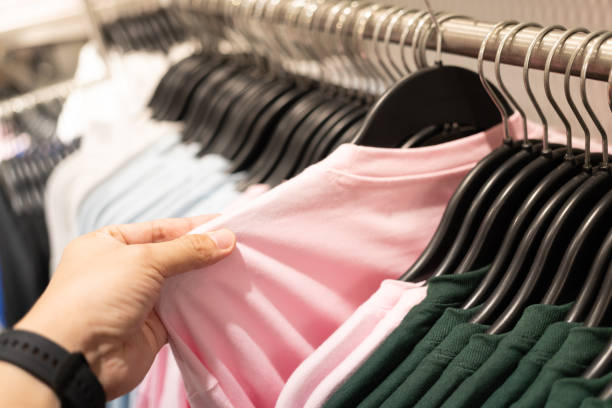 istock man choosing clothes at store. 1766240337
