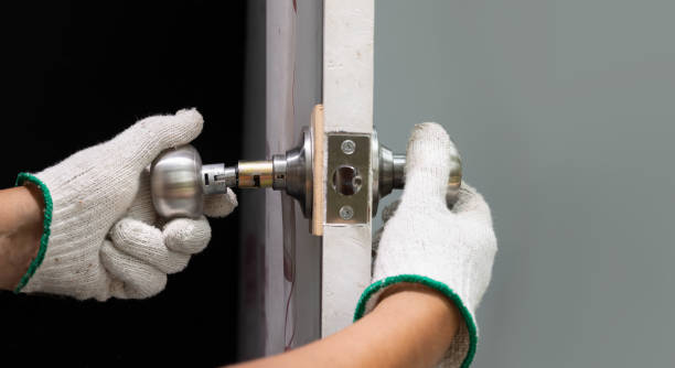 istock Locksmith repairing a broken door knob. 1766241220