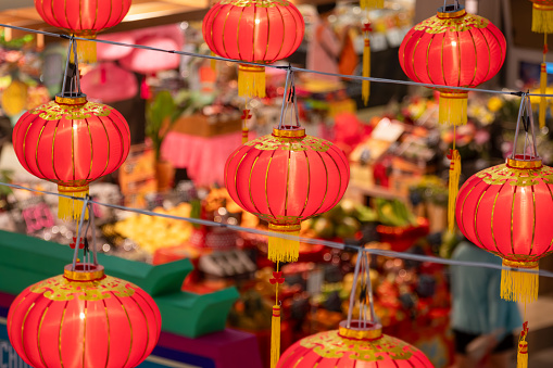 Hong Kong - January 26, 2024 : People select new year decorations at street market ahead of Chinese New Year in Hong Kong.