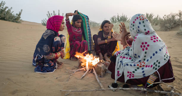 istock Indian kids setting up bonfire on sand dune 1766268841