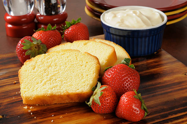Strawberry shortcake ingredients Sliced pound cake, fresh strawberries and whipped cream on a cutting board pound cake stock pictures, royalty-free photos & images