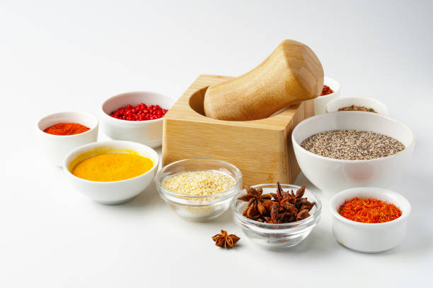 istock Wooden mortar with spices on white background 1766322880