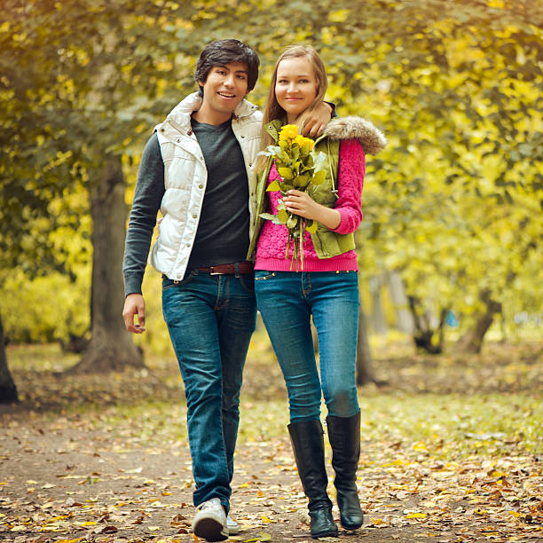 istock Happy young couple in autumn park 176634950
