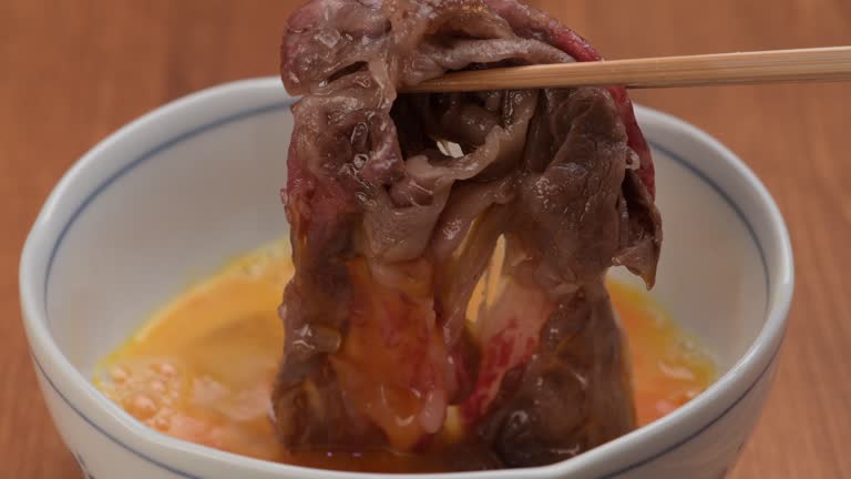 Dipping Sukiyaki Meat in Beaten Egg
Dipping Sukiyaki Meat in Beaten Egg
Dipping Sukiyaki Meat in Beaten Egg