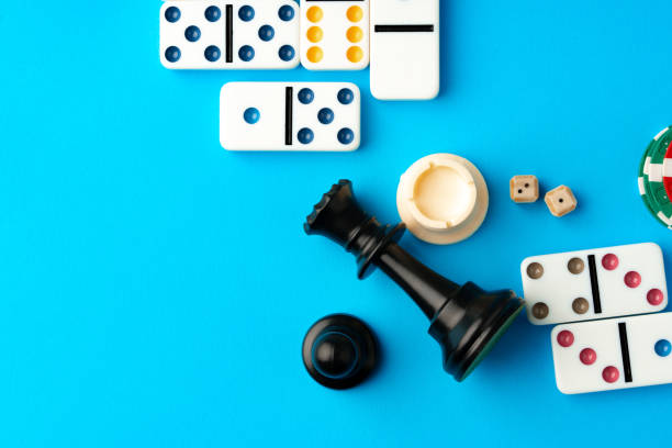 istock Chess figures and domino tiles on blue background 1766357838