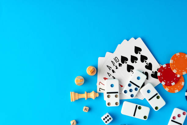 istock Items for playing chess, poker and domino on blue background studio shot 1766366322
