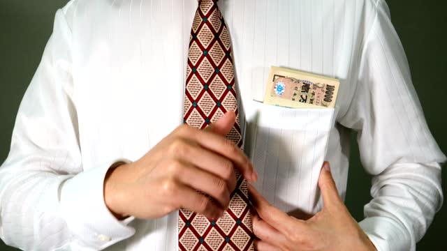 Businessman putting money in his pocket