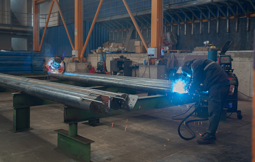 Industrial Welders Working In Factory