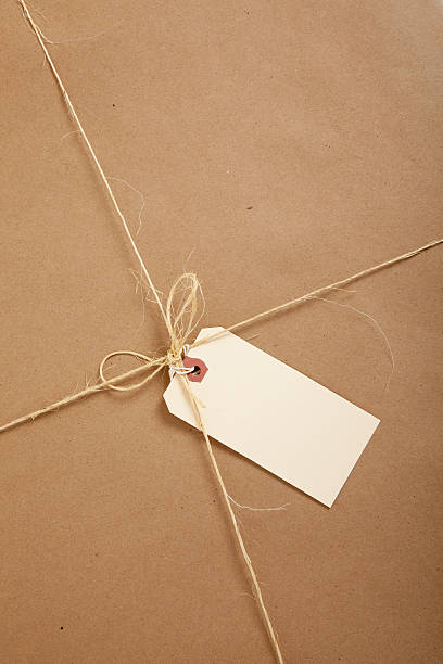 istock Box wrapped in brown paper with blank tag 176639858