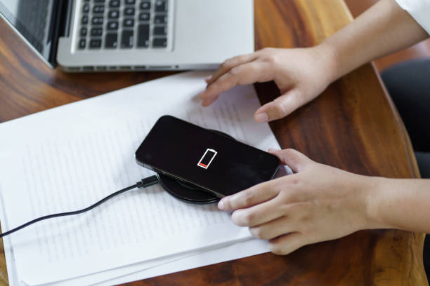 istock Charging mobile phone battery with wireless charging device in t 1766407852