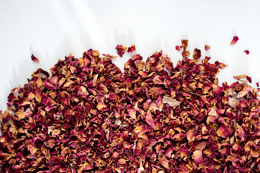tea from rose petals on a white background, tea leaves, dried rose petals, drinking herbal tea