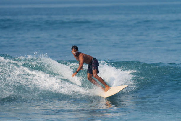 istock Indonesian Surfer Surfing with Longboard 1766426974
