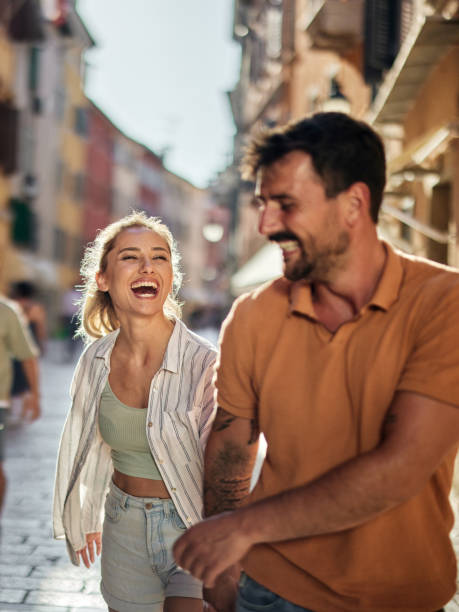 istock Cheerful couple having fun while running on the street. 1766445685