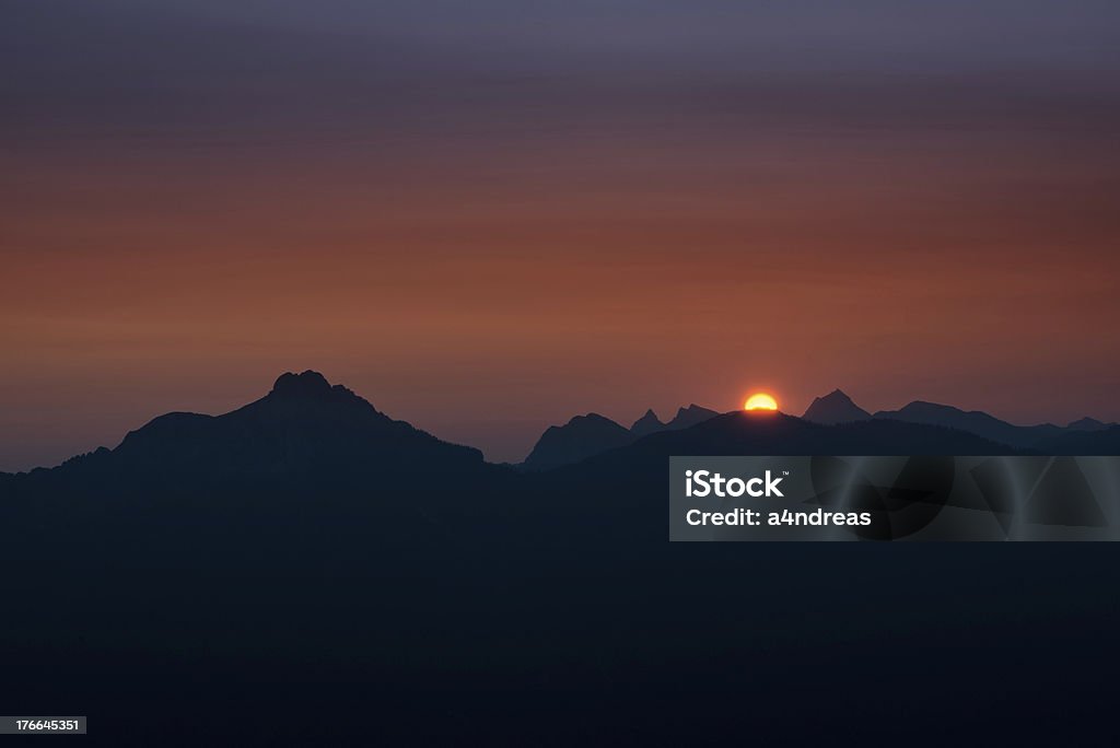 dawn z orange Piłka słońca znajdującego się za Łańcuch górski - Zbiór zdjęć royalty-free (Austria)