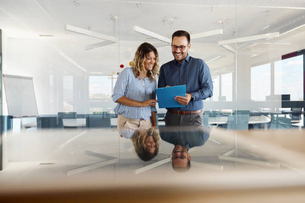 istock Happy business colleagues reading reports in the office. 1766463506