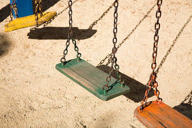 istock colourful swings in playground 176646548