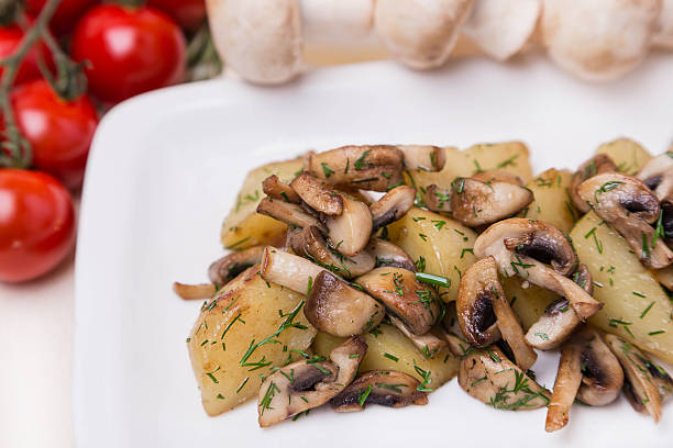 istock hot potato and mushroom with garnish on white plate 176646724