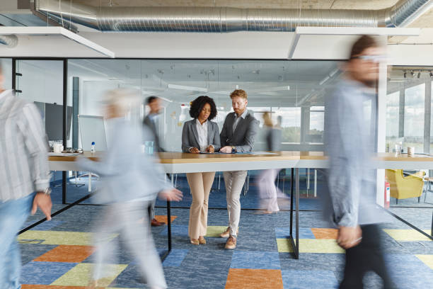 istock Young business people working on reports among colleagues in blurred motion. 1766477331
